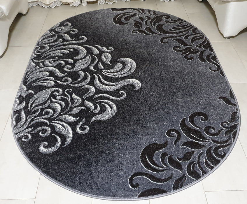 Covor oval gri amplasat sub masa in living design elegant si potrivit pentru spatii moderne