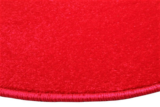 Detaliu covor rosu rotund cu textura premium si finisaj de calitate pentru interior modern